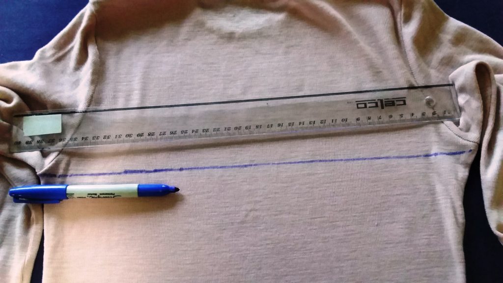 2. Rule a line across the garment. 2. Rule a line across the garment.