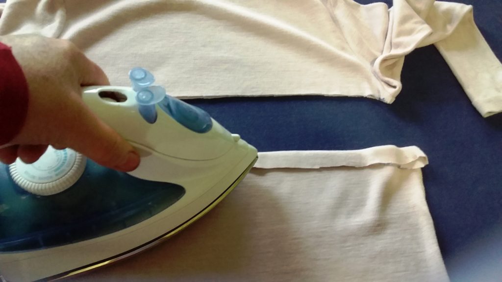 4. Turn the raw edge over and press it flat. 4. Turn the raw edge over and press it flat.