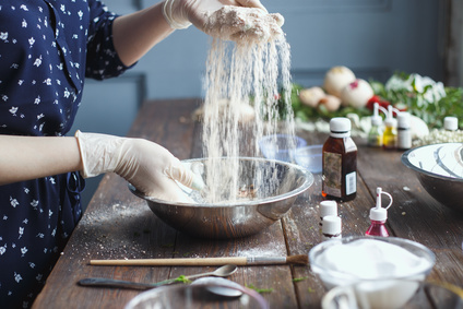 Preparation of bath bombs. Ingredients and floral decor on a wooden vintage table.