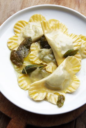 spinach ravioli with ricotta in a bowl on a wooden table. rustic style . Healthy comfort Italian food