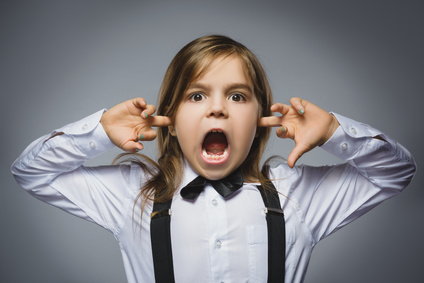 Closeup portrait of screaming girl covering her ears, observing. Hear nothing. Human emotions, facial expressions.
