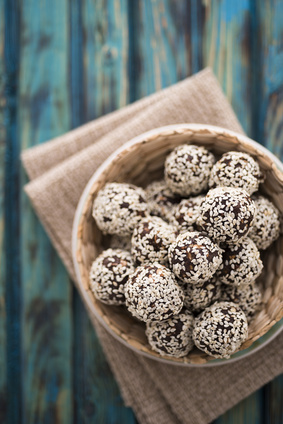 Raw cocoa candies with sesame seeds