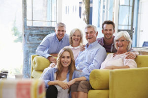 Extended Family Group At Home Relaxing In Lounge