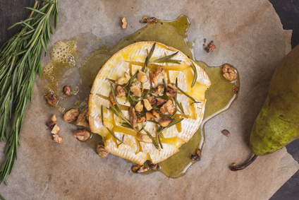 Delicious baked camembert with honey, walnuts, herbs and pears