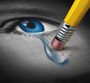 Depression Relief and conquering mental adversity with a pencil eraser removing a tear drop from a close up of a human face and eye as a concept of emotional support and therapy.