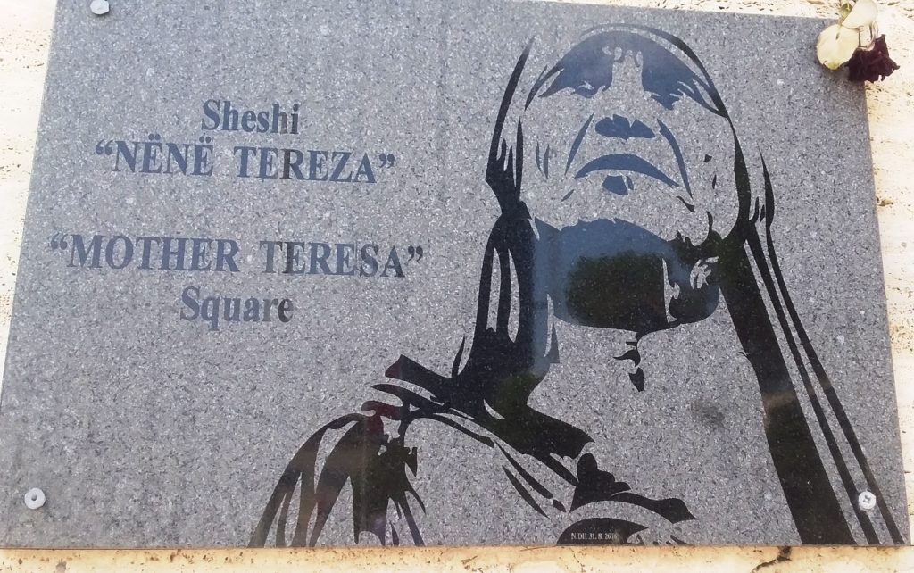 The large plaque in Mother Teresa Square Tirane. Note the floral tribute top right corner. 1