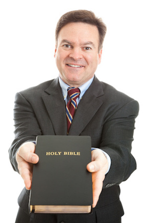 Minister, missionary, or bible salesman, presenting the bible to you. Isolated on white.