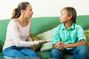 teenager and mother having serious talking in home
