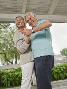 Senior couple dancing on veranda