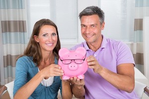 Portrait Of A Smiling Couple Holding Piggybank
