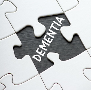 The word DEMENTIA under a missing jigsaw puzzle piece