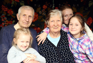 family portrait with granddaughters and grandparents at home