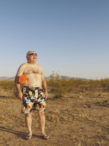 Senior Mixed Race man wearing bathing suit in desert