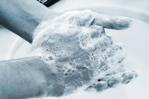 a man washing his hands with soap