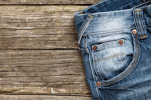 Jeans on old wooden background.
