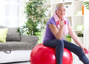 Senior woman exercising at home and smiling