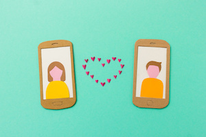 Internet love - Online dating concept with girl and boy falling in love via smartphone