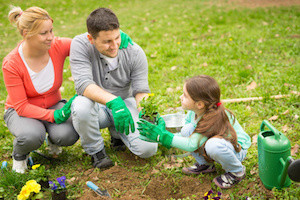 Family planting flowers