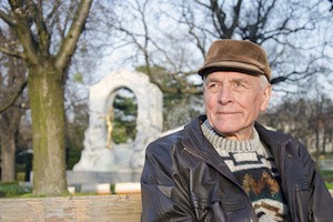 The senior sitting on the bench in the City park of Vienna, Austria.