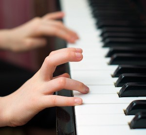 Child learns to play the piano.