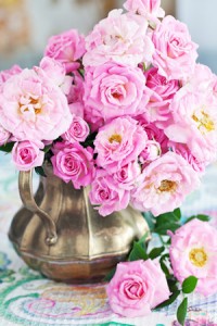 Arrangement with a fresh pink roses on a table.