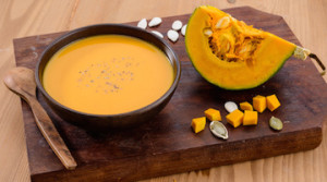 Pumpkin soup on wooden board