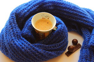 cup of coffee and chocolate in a scarf and chocolates candies