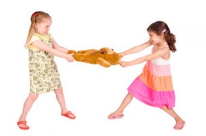 little girls fighting over a toy