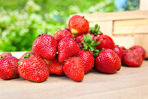 juicy sweet strawberry on a wooden table in garden