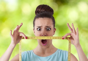 woman with tape measure worried about weight