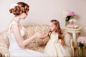 Flower girl playing with bride