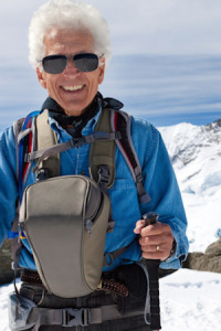 Active senior man hiking in the snowy mountains